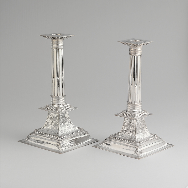 Trial lot 002: Two Silver-Tone Candlesticks with Decorated Square Bases
